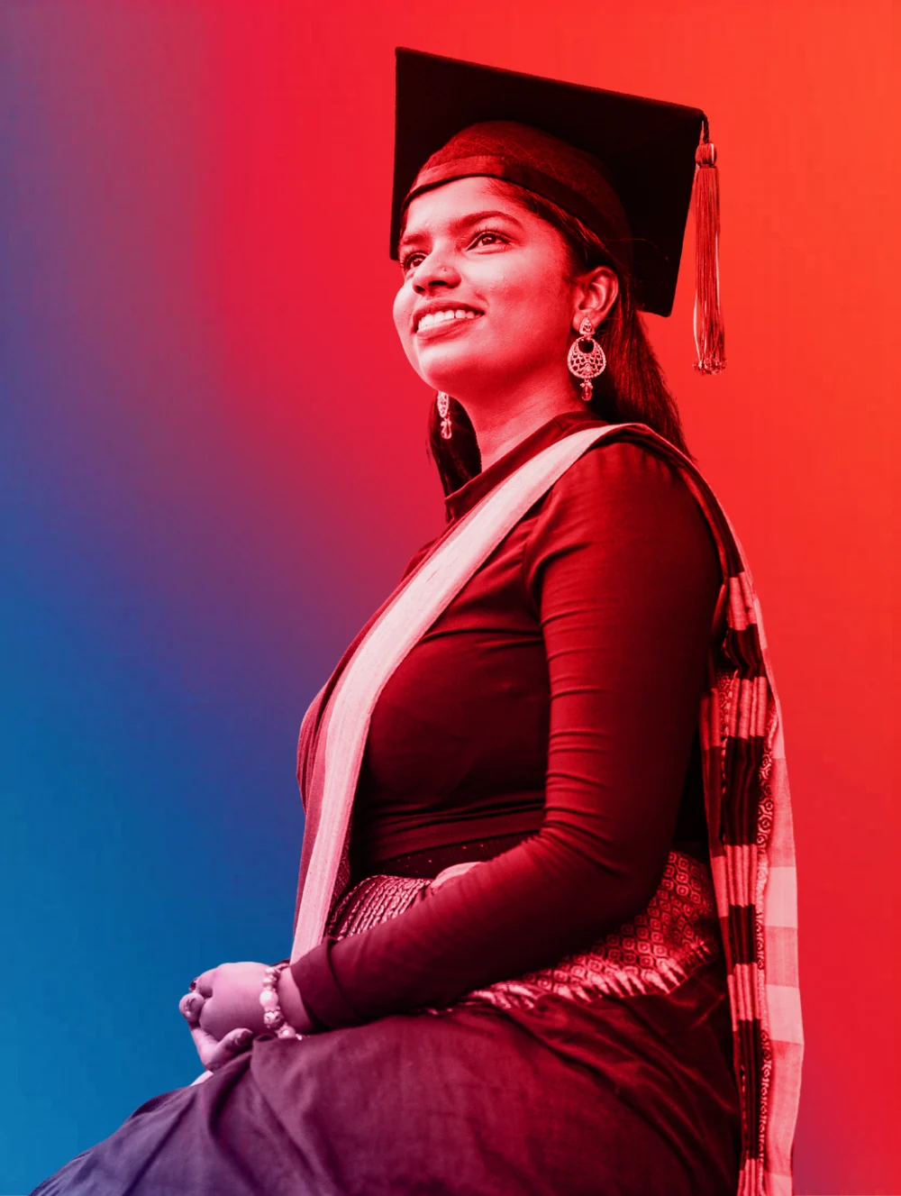 Pauline Suzanna in graduation attire posing for a professional portrait